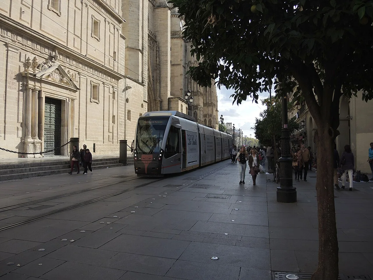 A MetroCentro tram beside Seville Cathedral, photographed in 2014.